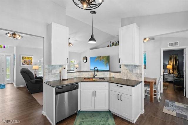 kitchen featuring stainless steel dishwasher, visible vents, a sink, and lofted ceiling
