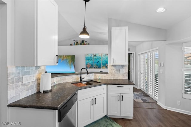 kitchen featuring dark wood-type flooring, white cabinets, vaulted ceiling, dishwasher, and a sink
