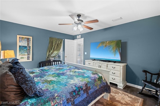 bedroom featuring ceiling fan, baseboards, dark wood finished floors, and visible vents