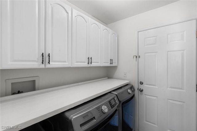 laundry area with independent washer and dryer and cabinet space