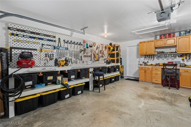 garage featuring a garage door opener and a workshop area