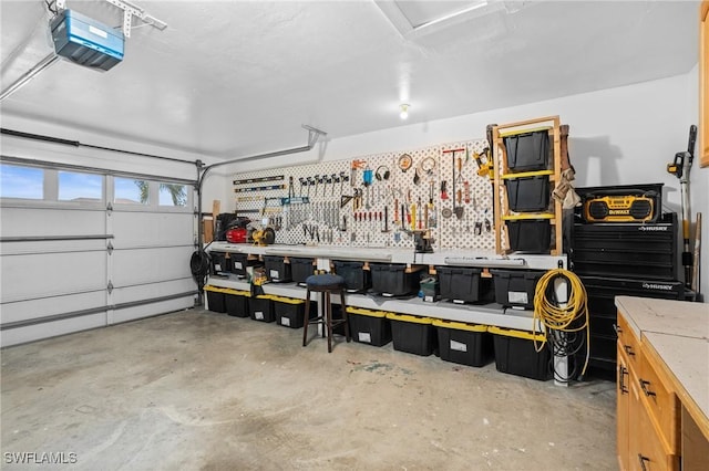 garage with a garage door opener and a workshop area