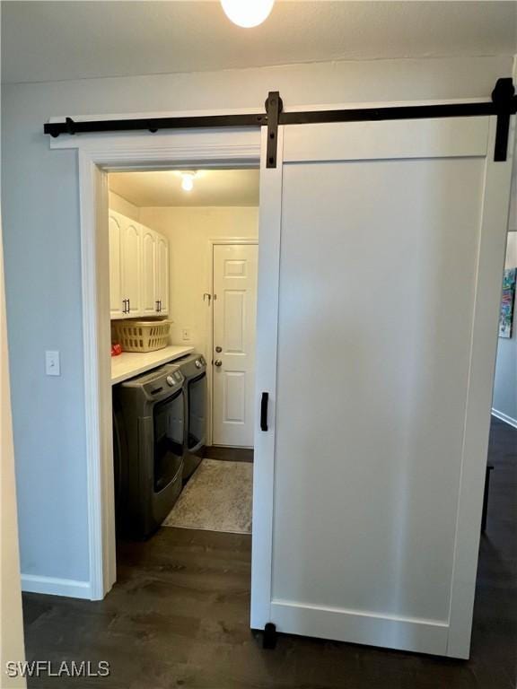 1511 SW 29th Ter, Cape Coral, FL 33914 - laundry room with a barn door, cabinet space, independent washer and dryer, and dark wood-type flooring