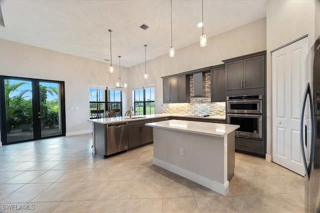 kitchen with a peninsula, light countertops, visible vents, decorative backsplash, and stainless steel appliances