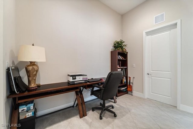 office area featuring light tile patterned floors, visible vents, and baseboards
