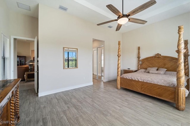 bedroom with visible vents, baseboards, a closet, a ceiling fan, and wood finished floors