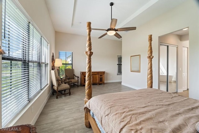 bedroom with light wood-type flooring, ceiling fan, and baseboards