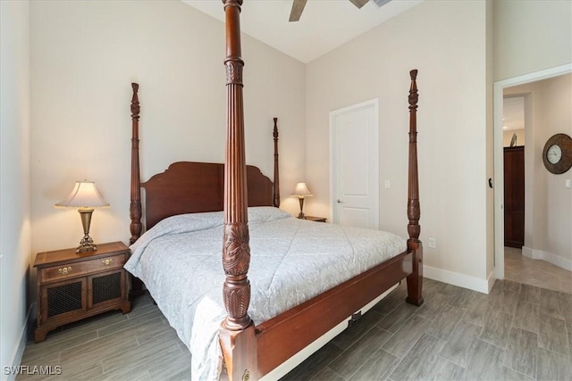 bedroom featuring lofted ceiling, baseboards, a ceiling fan, and wood finished floors
