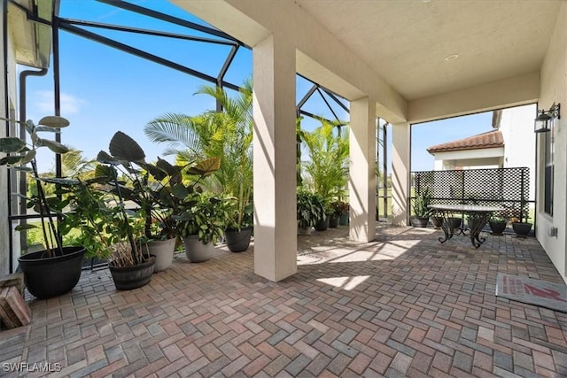 view of patio / terrace featuring glass enclosure