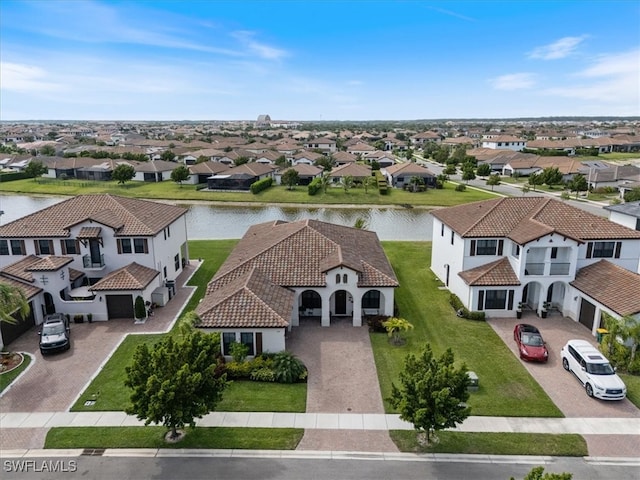 birds eye view of property with a residential view and a water view