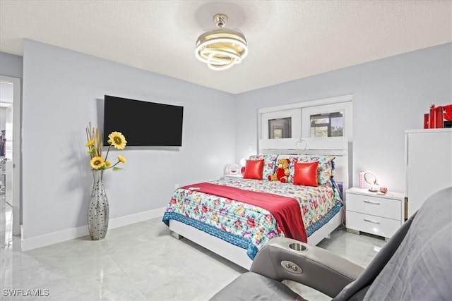 25068 Harborview Rd Unit 1B, Punta Gorda, FL 33980 - bedroom with baseboards and a textured ceiling