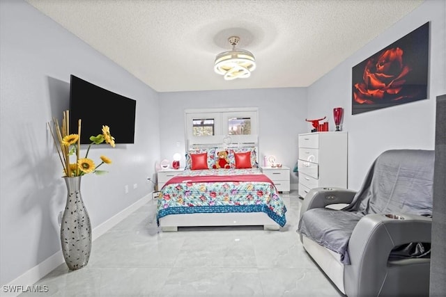 25068 Harborview Rd Unit 1B, Punta Gorda, FL 33980 - bedroom featuring baseboards and a textured ceiling