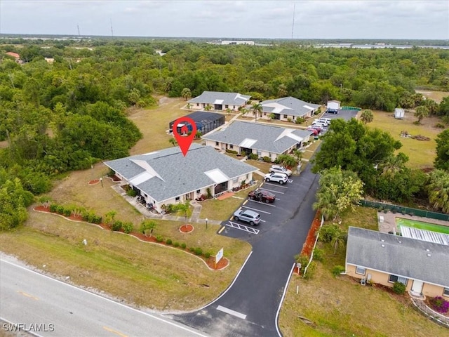 25068 Harborview Rd Unit 1B, Punta Gorda, FL 33980 - birds eye view of property featuring a forest view