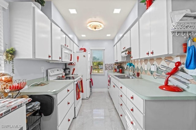 25068 Harborview Rd Unit 1B, Punta Gorda, FL 33980 - kitchen with white cabinets, light countertops, white appliances, and a sink