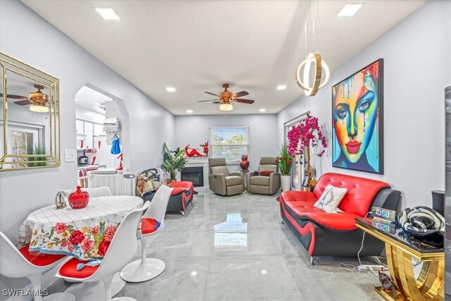 25068 Harborview Rd Unit 1B, Punta Gorda, FL 33980 - living area with marble finish floor, a ceiling fan, a glass covered fireplace, and recessed lighting