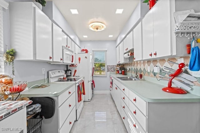 25068 Harborview Rd Unit 1B, Punta Gorda, FL 33980 - kitchen featuring tasteful backsplash, a sink, white appliances, light countertops, and white cabinetry