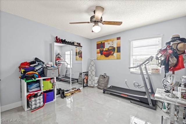 25068 Harborview Rd Unit 1B, Punta Gorda, FL 33980 - exercise room featuring a textured ceiling and a ceiling fan