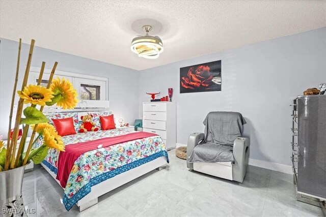 25068 Harborview Rd Unit 1B, Punta Gorda, FL 33980 - bedroom with baseboards and a textured ceiling