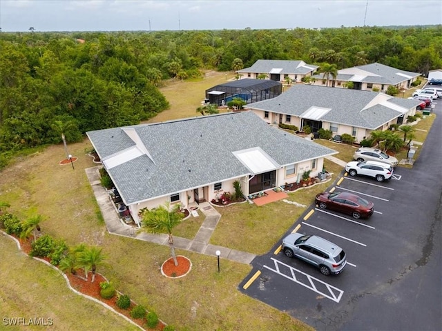 25068 Harborview Rd Unit 1B, Punta Gorda, FL 33980 - birds eye view of property featuring a wooded view