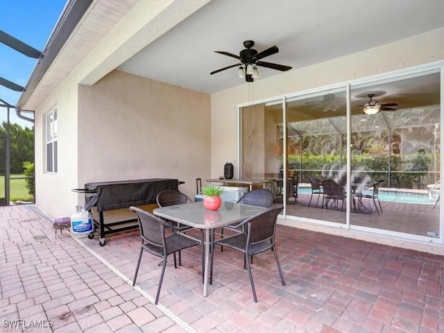 8143 Monticello Ct, Naples, FL 34104 - view of patio featuring a ceiling fan, outdoor dining area, and glass enclosure