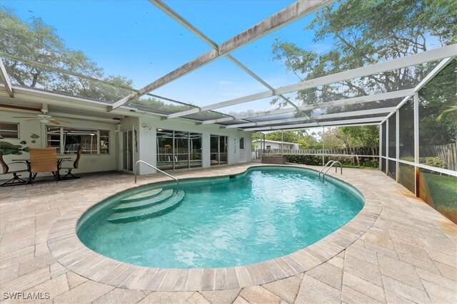 1147 Shady Rest Ln, Naples, FL 34103 - view of swimming pool featuring a patio area, ceiling fan, and glass enclosure