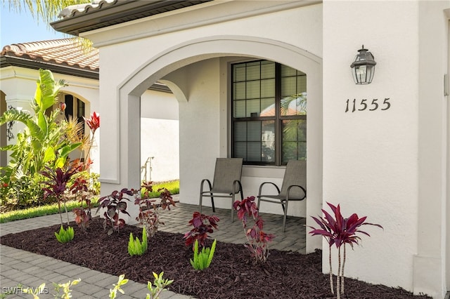 11555 Golden Oak Ter, Fort Myers, FL 33913 - property entrance featuring stucco siding and a tile roof