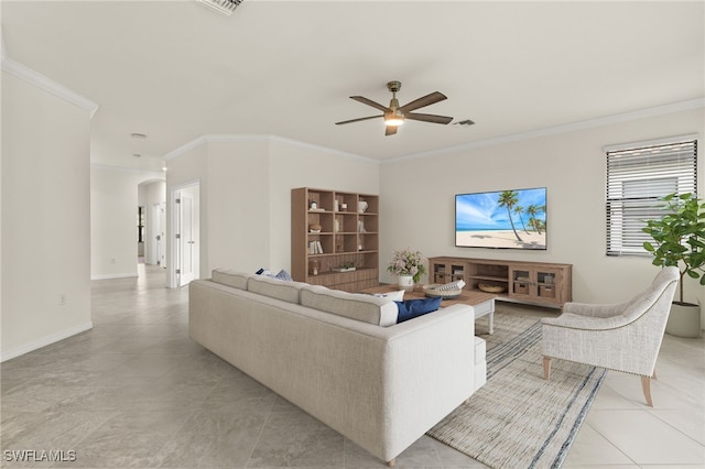 11555 Golden Oak Ter, Fort Myers, FL 33913 - living room with light tile patterned floors, baseboards, arched walkways, a ceiling fan, and crown molding