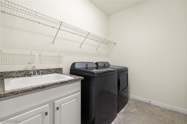 11555 Golden Oak Ter, Fort Myers, FL 33913 - clothes washing area with light tile patterned floors, baseboards, a sink, independent washer and dryer, and cabinet space