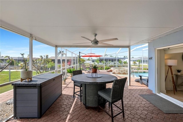 6325 Park Rd, Fort Myers, FL 33908 - view of patio featuring glass enclosure, a pool with connected hot tub, ceiling fan, and outdoor dining area