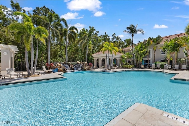 pool featuring a patio area and fence