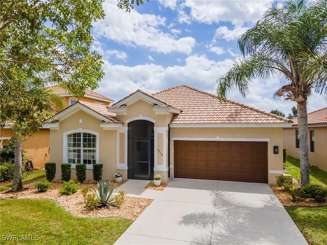 mediterranean / spanish-style home with stucco siding, driveway, a tile roof, and a garage