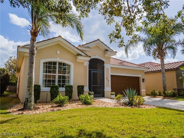 mediterranean / spanish home featuring stucco siding, a front lawn, driveway, and an attached garage