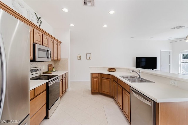 kitchen featuring decorative backsplash, a sink, visible vents, stainless steel appliances, and light countertops