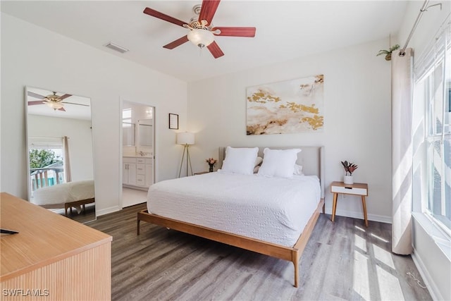 bedroom with visible vents, ceiling fan, wood finished floors, and baseboards