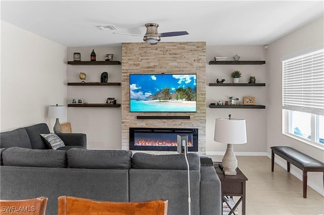 8880 Cascade Price Cir, North Fort Myers, FL 33917 - living area featuring a ceiling fan, light tile patterned floors, and a stone fireplace