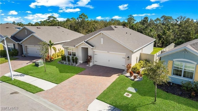 8880 Cascade Price Cir, North Fort Myers, FL 33917 - single story home featuring an attached garage, decorative driveway, stucco siding, and a front lawn