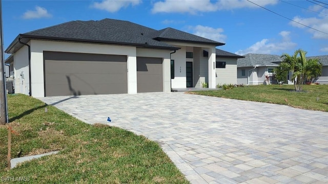 308 SW 13th Ct, Cape Coral, FL 33991 - view of front of home featuring central air condition unit, stucco siding, decorative driveway, a front yard, and an attached garage