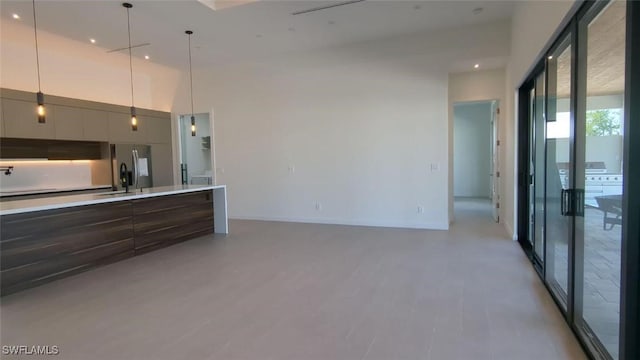 308 SW 13th Ct, Cape Coral, FL 33991 - kitchen with modern cabinets, light countertops, a sink, hanging light fixtures, and baseboards