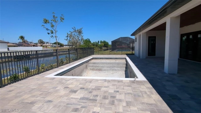 308 SW 13th Ct, Cape Coral, FL 33991 - view of pool featuring a fenced in pool, a patio area, a fenced backyard, a lanai, and a water view