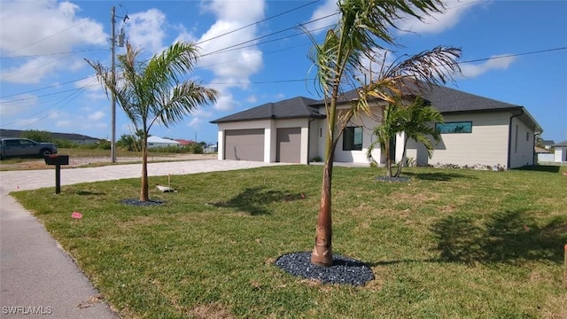 308 SW 13th Ct, Cape Coral, FL 33991 - view of front facade featuring an attached garage, a front lawn, and decorative driveway