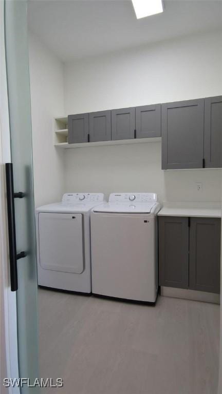 308 SW 13th Ct, Cape Coral, FL 33991 - laundry area with washing machine and clothes dryer and cabinet space