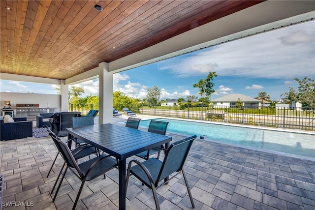 308 SW 13th Ct, Cape Coral, FL 33991 - fenced backyard with an outdoor kitchen, a patio, and outdoor dining area