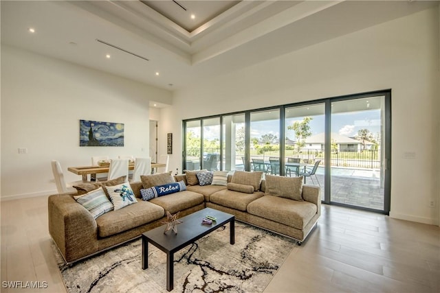 308 SW 13th Ct, Cape Coral, FL 33991 - living room with wood finished floors, a towering ceiling, recessed lighting, and a tray ceiling