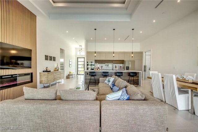 308 SW 13th Ct, Cape Coral, FL 33991 - living room with recessed lighting, a high ceiling, and a glass covered fireplace