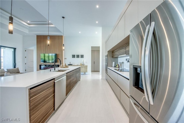 308 SW 13th Ct, Cape Coral, FL 33991 - kitchen with stainless steel appliances, modern cabinets, white cabinetry, light countertops, and open floor plan