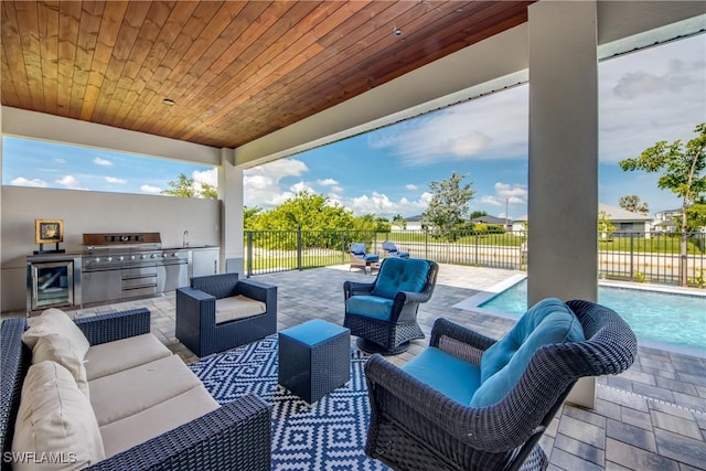 308 SW 13th Ct, Cape Coral, FL 33991 - fenced backyard featuring an outdoor living space, wine cooler, area for grilling, and a patio