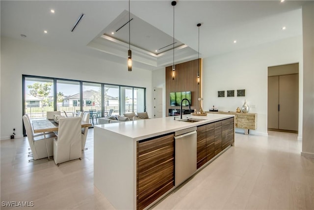 308 SW 13th Ct, Cape Coral, FL 33991 - kitchen with modern cabinets, stainless steel dishwasher, a towering ceiling, brown cabinets, and light countertops