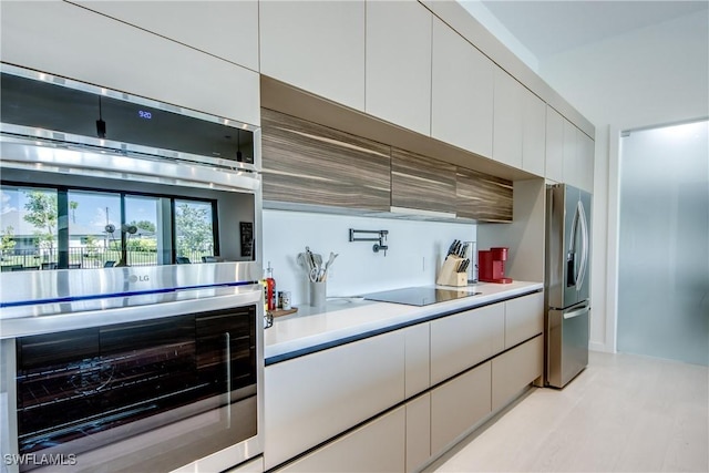 308 SW 13th Ct, Cape Coral, FL 33991 - kitchen featuring stainless steel appliances, white cabinetry, light countertops, and modern cabinets