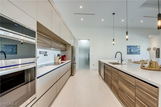 308 SW 13th Ct, Cape Coral, FL 33991 - kitchen featuring stainless steel appliances, modern cabinets, white cabinetry, and light countertops