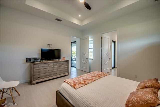308 SW 13th Ct, Cape Coral, FL 33991 - bedroom with a raised ceiling, light wood-style floors, and ceiling fan